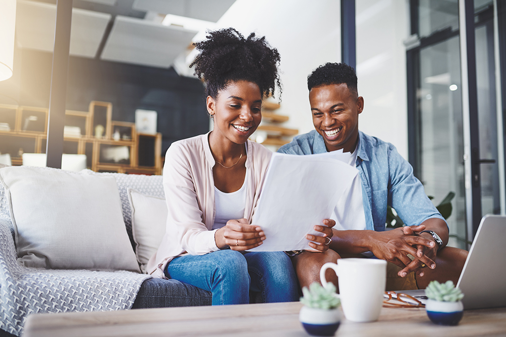 A man and a woman looking at a paper.